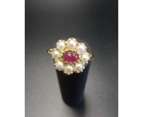 RUBY AND PEARL CLUSTER DRESS RINGthe central oval cabochon ruby in eight diamond surround, on eighteen carat gold shank, ring