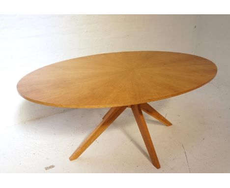 LIGHT OAK OVAL DINING TABLEwith a segmented design top standing on four cross shaped supports, 190cm wide 