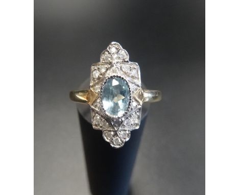 ART DECO STYLE AQUAMARINE AND DIAMOND PLAQUE RINGthe central oval cut aquamarine in multi diamond surround, on nine carat gol