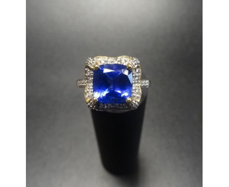 IMPRESSIVE TANZANITE AND DIAMOND CLUSTER DRESS RINGthe central cushion cut tanzanite approximately 2.5cts, in diamond surroun