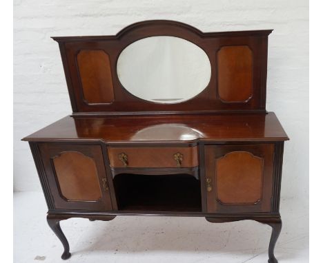 MAHOGANY BREAKFRONT SIDEBOARDwith a shaped raised back centered with an oval bevelled mirror, flanked by a pair of quarter ve