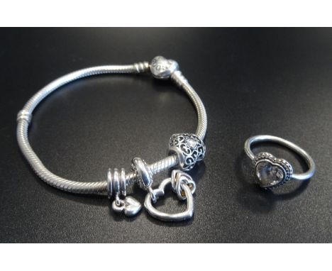 PANDORA MOMENTS SILVER CHARM BRACELETwith three Pandora charms; together with a Pandora Sparkling Heart CZ set silver ring 