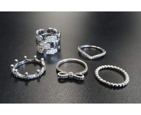 PANDORA AND SWAROVSKI RINGScomprising four silver Pandora examples: Shimmering Wish, Delicate Bow, Enchanted Crown and Bubble