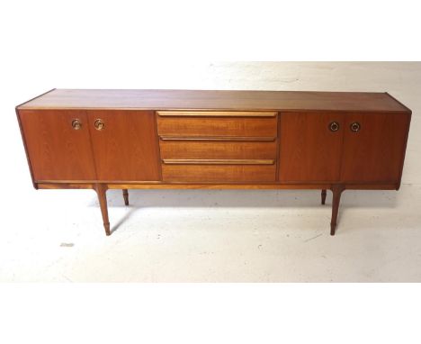 1970s TEAK MCINTOSH SIDEBOARDcomprising three drawers with moulded handles flanked by two double door cupboards with metal ri