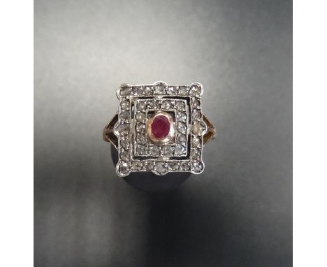 ART DECO STYLE RUBY AND DIAMOND CLUSTER RINGthe central oval cut ruby in double old cut diamond surround, on nine carat rose 