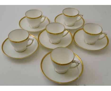 A set of six Minton bone china coffee cups and saucers, "Golden Heritage" pattern H-5183, white, with a gilt tooled rim