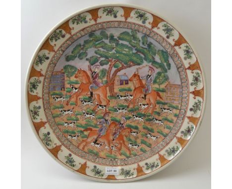 A Chinese ceramic charger, decorated with a European hunting scene, intended for the export market, painted in the famille ro