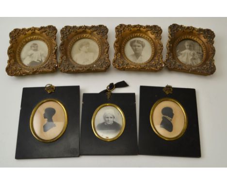 A pair of 19th century silhouettes, oval mounted within ebonised frames with gilt brass floral ring mounts, 13cm x 11cm, toge