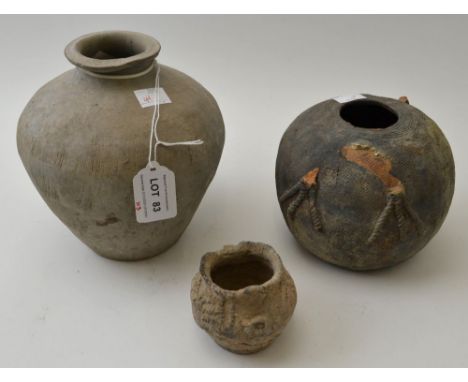 A Chinese ceramic vase, grey tinted, considered to be Neolithic, 16cm high, together with two other early Chinese pots (3)&nb