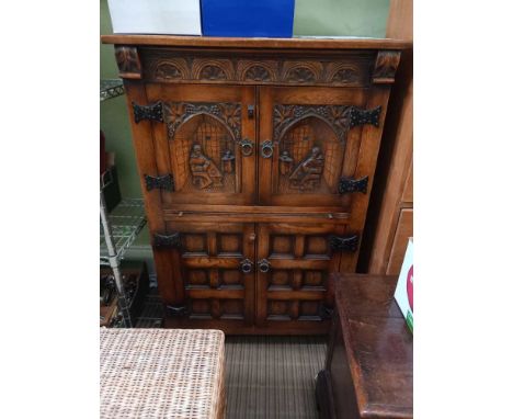 A "Reprodux" oak drinks cabinet, carved and panelled decoration, in the 17th century style, 84cm wide