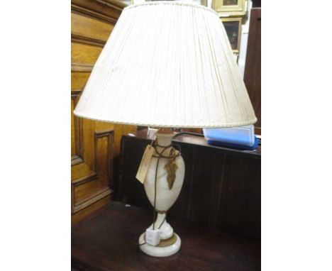 A white onyx and gilt mounted lamp with pleated coffee coloured shade  