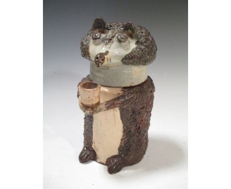 A pottery bear tobacco jar and cover  