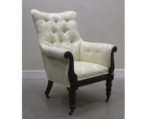 A William IV mahogany framed armchair, button upholstered in a silk damask fabric, on turned legs  