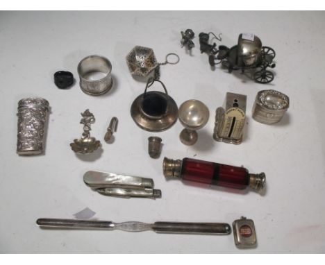 A collection of silver and other items to include a ruby glass double ended scent bottle and a set of silver postal scales, f