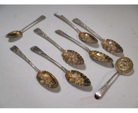 Seven various silver gilt berry spoons and a ladle, 14oz, (8)  