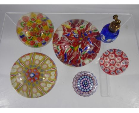 Three Vintage Multi Coloured Cane Paperweights, together with two miniature paperweights and a glass scent bottle. (6)