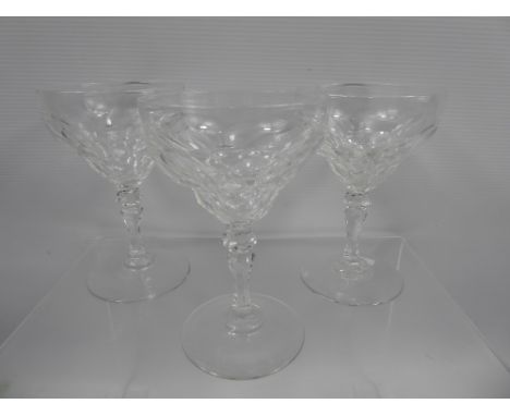 A Set of Thirteen Vintage Cut Glass Champagne Glasses, the cup-form glasses having a stepped bowl with knop stem, approx 14 c