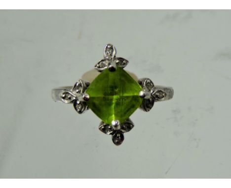 A Lady's Gems 18 ct Gold White Gold Peridot and Diamond Ring, peridot measures  1.88 ct dias 12.1mm 0.048 ct, size R, approx 