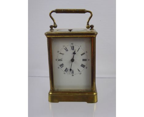 A French Brass Cased Mantel Clock, white enamel face with Roman dial, S & F Movement, approx 19 x 9.5 cms.