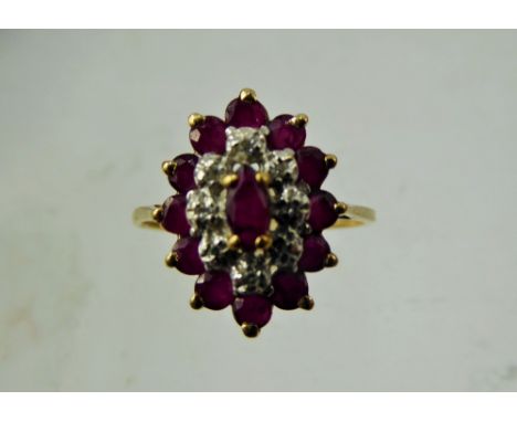 A Lady's Vintage 9 ct Yellow Gold Marquise Ruby and Diamond Ring, the single ruby 5 x 2.5 mm, 12 x 2.6mm ruby surround and 8 