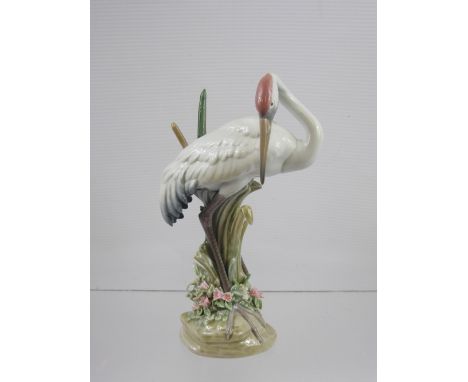 A Lladro Figure of a Crane in Reeds, decorated in muted polychrome  with applied flowers and foliage, printed, incised and im