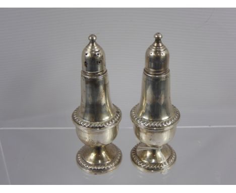 A Pair of Empire Sterling Weighted Silver Glass Lined Peppers.
