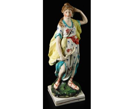 An early 19thC Staffordshire pottery figure Diana, holding her bow and taking out a arrow from her quiver, on a square base, 