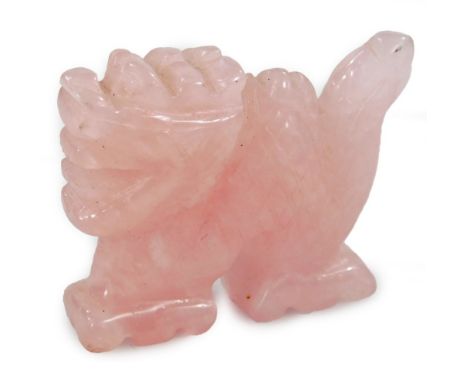 A Chinese carved pink jade style dragon pendant, in standing pose, 4cm H.