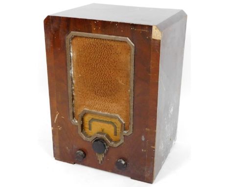 A mid 20thC walnut cased radio, with front material speaker and articulated Bakelite tuning knops, 50cm H, 67cm W, 31cm D.