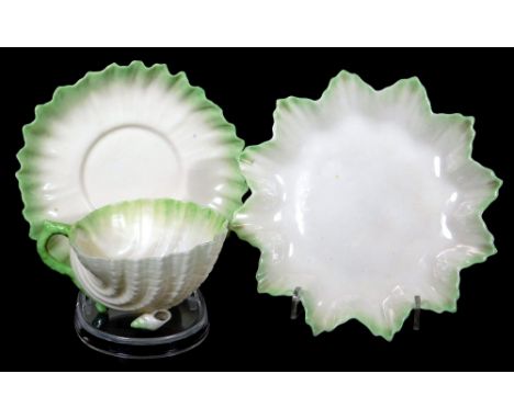 An early 20thC Belleek porcelain shell pattern trio, comprising of a cup, 12cm H, saucer and side plate, in green colours wit