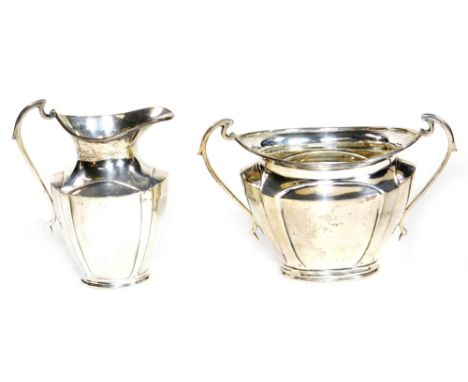 A George V silver two piece tea service, comprising of a milk jug and two handled sugar bowl, 11cm H, Sheffield 1918, 9½oz.  