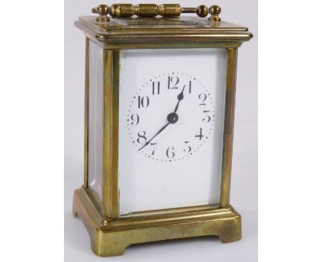 A 20thC brass carriage clock, the 6cm W back plate with Arabic numerals, in a five part glazed case, with a keywind single tr