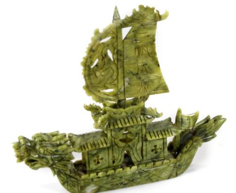 A Chinese jade model of a junk, in green, heavily carved, 29cm W.  (AF)
