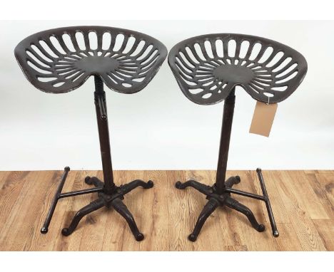 STOOLS, a set of eight tractor seat style, height adjustable, 81cm H at tallest approx, with adjustable foot rests. (8) 