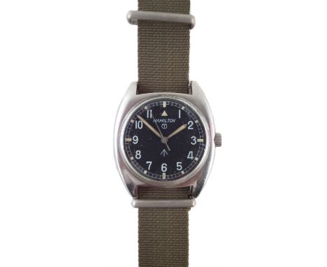 Hamilton military watch, stamped with broad arrow to reverse, and marked on the dial, on green strap. At the time of catalogu