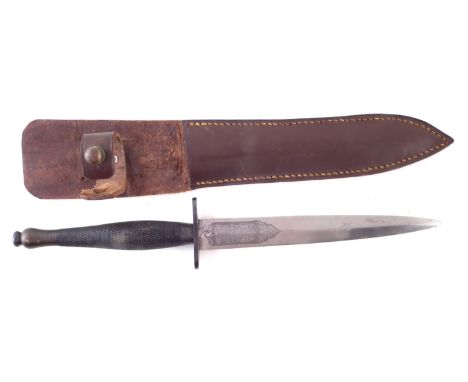 Fairbairn Sykes 2nd Pattern commando knife by Wilkinson Sword , with leather scabbard, the knife measures 30cm long.Condition