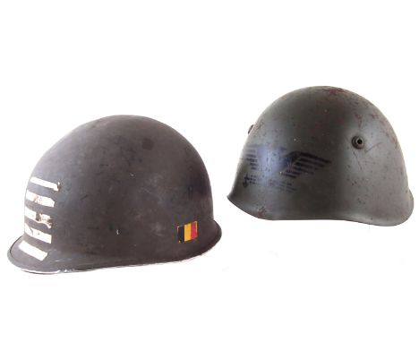 Two steel army helmets, with interior linings, one stencilled with an eagle.