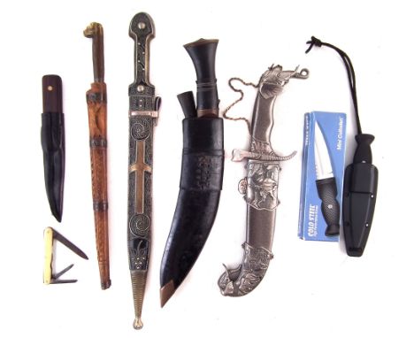 Collection of knives, to include a North African Flyssa and carved wood scabbard, a Kukri with its two small knives in scabba