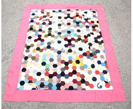 A 1920s patch work quilt flowers to one side and red and white check to the other 140cm x 197cm and another with hexagonal pa