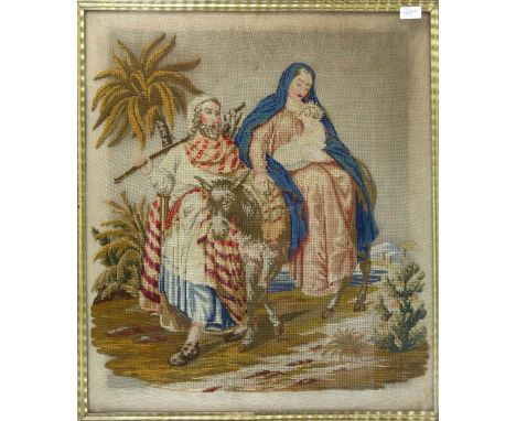 A 19th century wool work tapestry depicting Mary and baby Jesus on a donkey with  Joseph at her side, in maple frame 70cm x 6