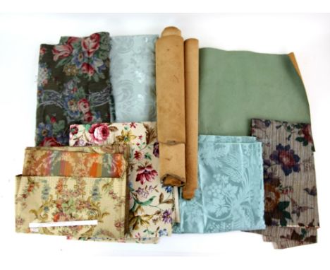 Assorted vintage remnants including turquoise silk brocade, Sanderson floral print, and woven floral and a roll of green leat