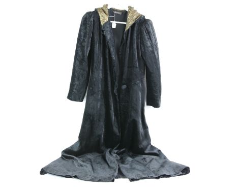 Channel model black evening cloak with gold coloured hood, a 1940s black ladies jacket wtihlabel L Guisse Essers and a black 