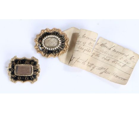 Two Victorian mourning brooches, the first with a central hair panel and black enamel surround and gilt lettering, the rear o