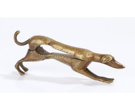 Novelty brass nutcracker, in the form of a greyhound with a hinged body, the inside of the body with the registration number 