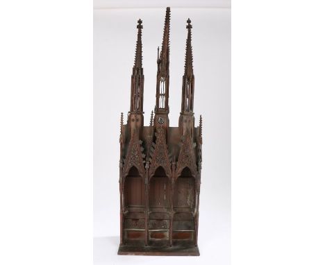 A good 19th Century mahogany model, of a church section with three spires above three arches carved with leaf and berries des
