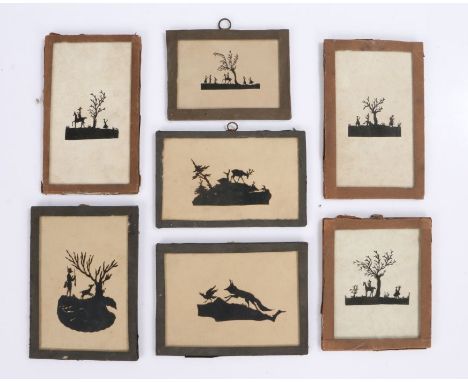 Collection of seven cut paper silhouette pictures, depicting various scenes of hunting and gatherings under trees, the larges