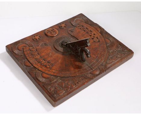Unusual carved fruitwood sundial, with a moon and stars above signs of the Zodiac and two carved scenes, one depicting a man 