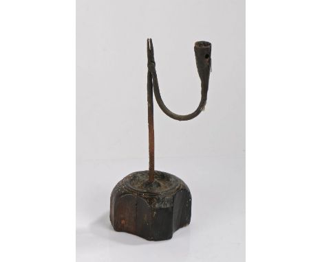 English table rush light and candle holder, circa 1800, the wrought iron arm with candlestick socket above the shaped wood ba