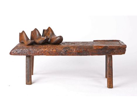 19th Century cobblers bench, the rectangular top with leather strap work to the centre and one end squared off with wide bead