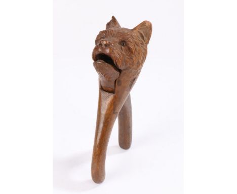 19th Century treen nutcracker, in the form of a dog set with glass eyes, 18cm long&nbsp;